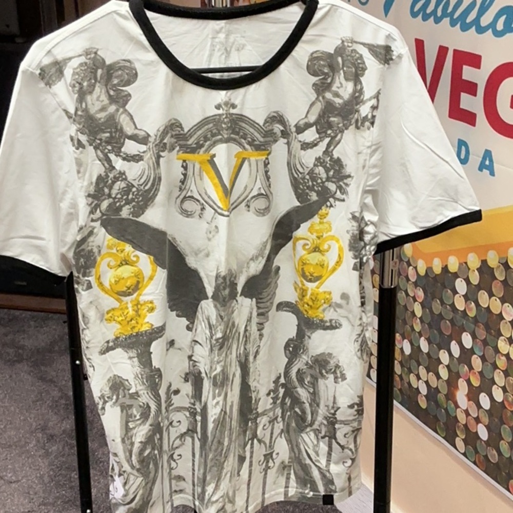 Elegant White and Gold Ringer Tee with Ornate Patterns